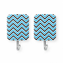 Two identical rectangular adhesive hooks with a blue and black chevron pattern are shown on a plain white background.