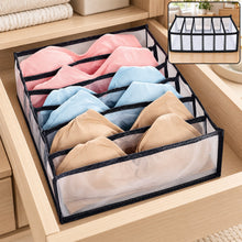 A 6-section drawer organizer filled with pink, blue, and beige bras sits inside a light wooden drawer. – view 8