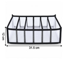A white mesh and black fabric 6-section drawer organizer with dimensions 31.5 cm length and 12 cm height.