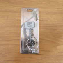 Metal hammer keychain displayed on a flat surface