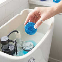 Toilet tank with blue cleaner tablet inside