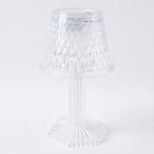 Modern LED crystal lamp displayed on a wooden shelf in a home setting.