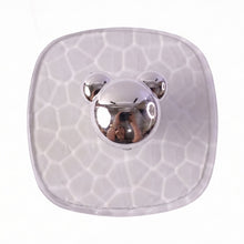 Multiple clear adhesive wall hooks installed discreetly on a bathroom wall.