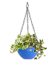 Stylish hanging flower pot with rattan-like texture, enhancing home decor.