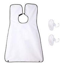 Man using a black beard apron with suction cups to catch hair clippings while shaving.