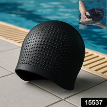 Swimmer wearing silicone swimming cap in pool water