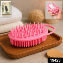 A pink silicone body brush with spiky bristles rests on a wooden tray, with an inset image showing it in use and a product