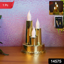 A golden triple LED flameless candle lamp stands on a wooden surface against a textured purple background.