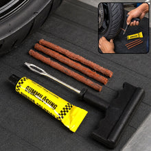 A tubeless tire repair kit with a rubber solution tube, three brown repair strips, and a T-handle tool on a black mat next