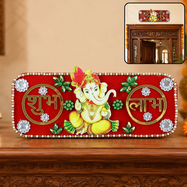 A red rectangular Ganesha Shubh Labh wall decor with white and green embellishments, displayed on a wooden surface.