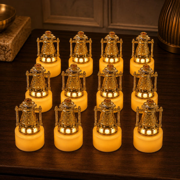 Twelve miniature gold lantern LED candles arranged in a grid on a dark wooden surface, emitting a warm glow.