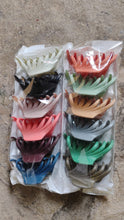 Vertical display of matte plastic hair clamp showing compact size