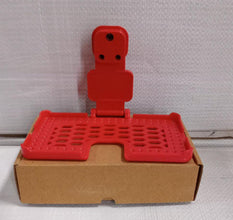 Lifestyle shot of the multi-purpose red wall holder, keeping cables tidy.