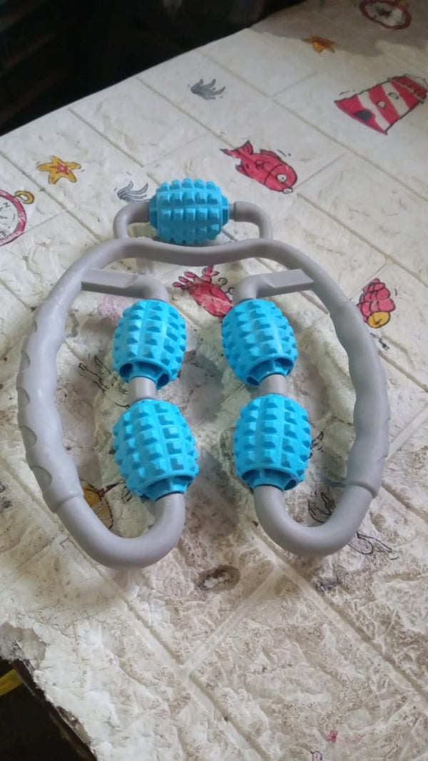 The muscle massage roller in action, targeting a user's arm for muscle relaxation.