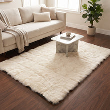 A cream fluffy faux fur rug on a wooden floor in a living room with a sofa, coffee table, and potted plant.
