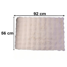 A rectangular cream fluffy faux fur rug with dimensions 92 cm by 56 cm indicated with arrows.