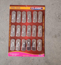 Stainless steel wall hooks securely holding keys and small accessories.
