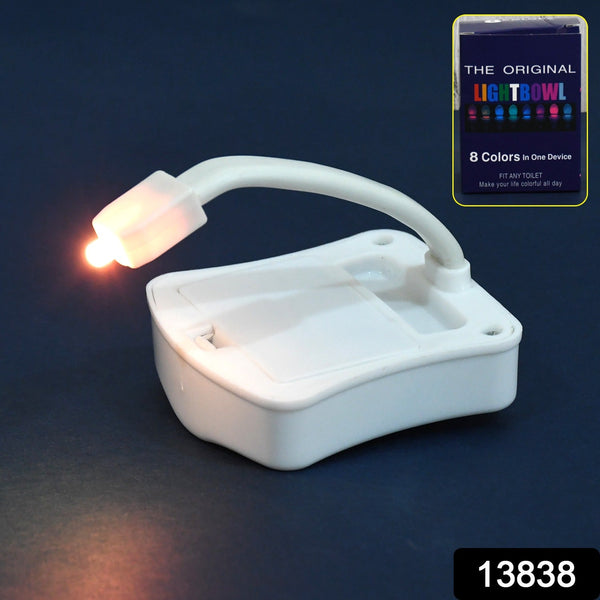 White motion sensor toilet light with a flexible arm, emitting an orange glow, next to its product packaging.