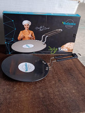 Close-up of riveted steel handle on non-stick roti tawa