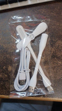 White USB fan, LED light, and charging cable sealed in clear plastic packaging.