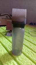 Front view of the professional hair comb applicator bottle, ready for use.