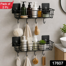 Two black metal wall-mounted storage baskets with hooks, filled with various bathroom products and hanging items, with a
