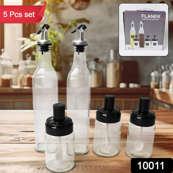 Transparent glass oil dispensers and spice jars with BPA-free rubber stoppers.