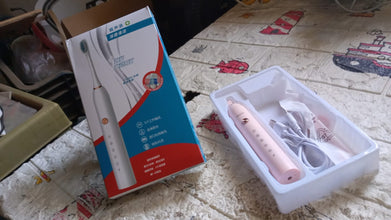 Detailed view of the Electric Toothbrush head, showing bristles and tongue cleaner.