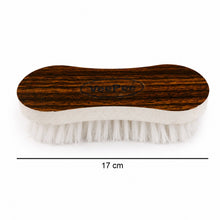 Size 17 cm curved laundry brush on wooden background