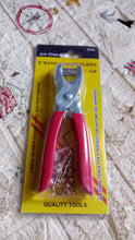 Red-handled grommet pliers in yellow packaging with text 