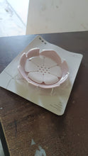 The white plastic soap dish displayed on a simple background.