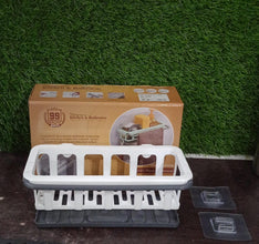 Hanging drain rack from Bathora, perfectly storing sponges and brushes for quick access.