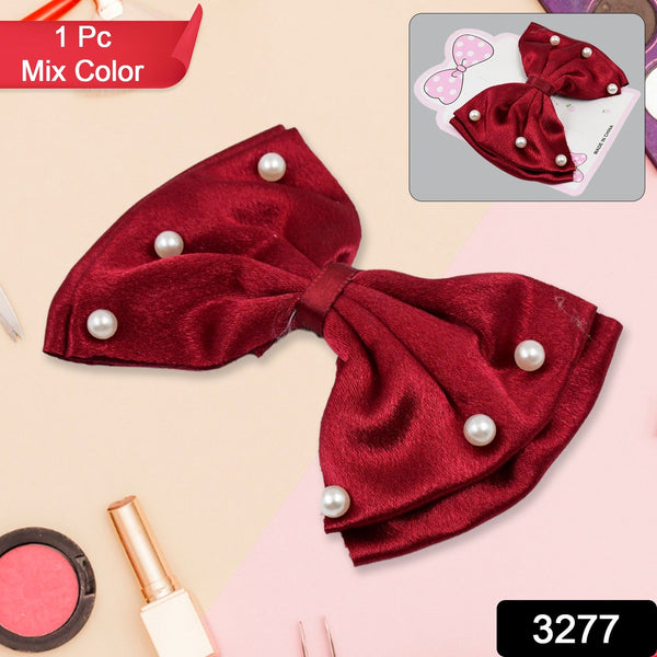Close-up of a fancy multicolour hair bow clip with a shiny heart.