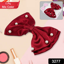 Close-up of a fancy multicolour hair bow clip with a shiny heart.