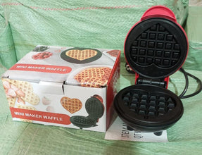 Mini waffle maker cooking freshly made waffles