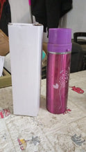 Stainless steel water bottle on a modern desk, promoting healthy office hydration.
