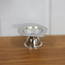 Spiritual puja decoration with stainless steel diya stand