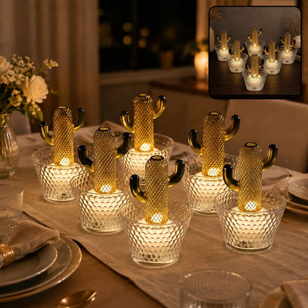 Six gold cactus LED lights in clear textured pots illuminate a dining table at night.