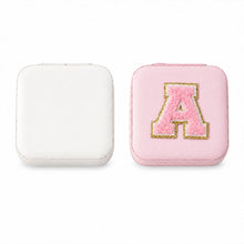 The LilyGleam travel jewellery box placed next to travel essentials like a passport and sunglasses.