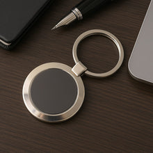 Durable round metal keychain with strong alloy build and black center.