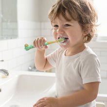 Colorful kids toothbrush featuring an animal-shaped whistle toy for engaging brushing