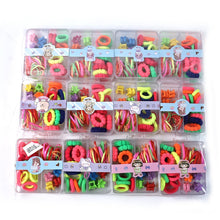Selection of colourful rubber bands and plastic hair clips suitable for children's hairstyles.