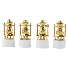 Three vintage lantern-style flameless LED tealights glowing in a dark setting.