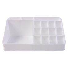 Pull-out drawer of the clear makeup organiser holding compacts and small items.