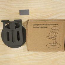 A black metal mobile stand next to its brown cardboard box labeled 
