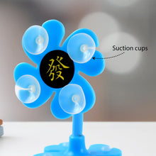 Close-up of a blue flower-shaped phone holder, highlighting the suction cups and Chinese character.