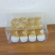 Twelve gold moon shaped flameless LED candles packaged in a clear plastic box on a wooden surface.