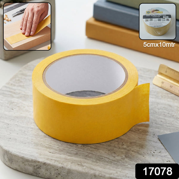 A large roll of yellow double-sided tape sits on a grey marble surface with a small inset image of the tape in use.