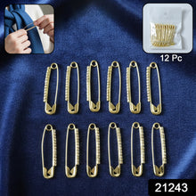 Close-up of single golden safety pin brooch showing stone detail and secure clasp