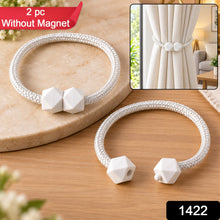 Two white braided rope curtain tiebacks with geometric white plastic fasteners, with a red 